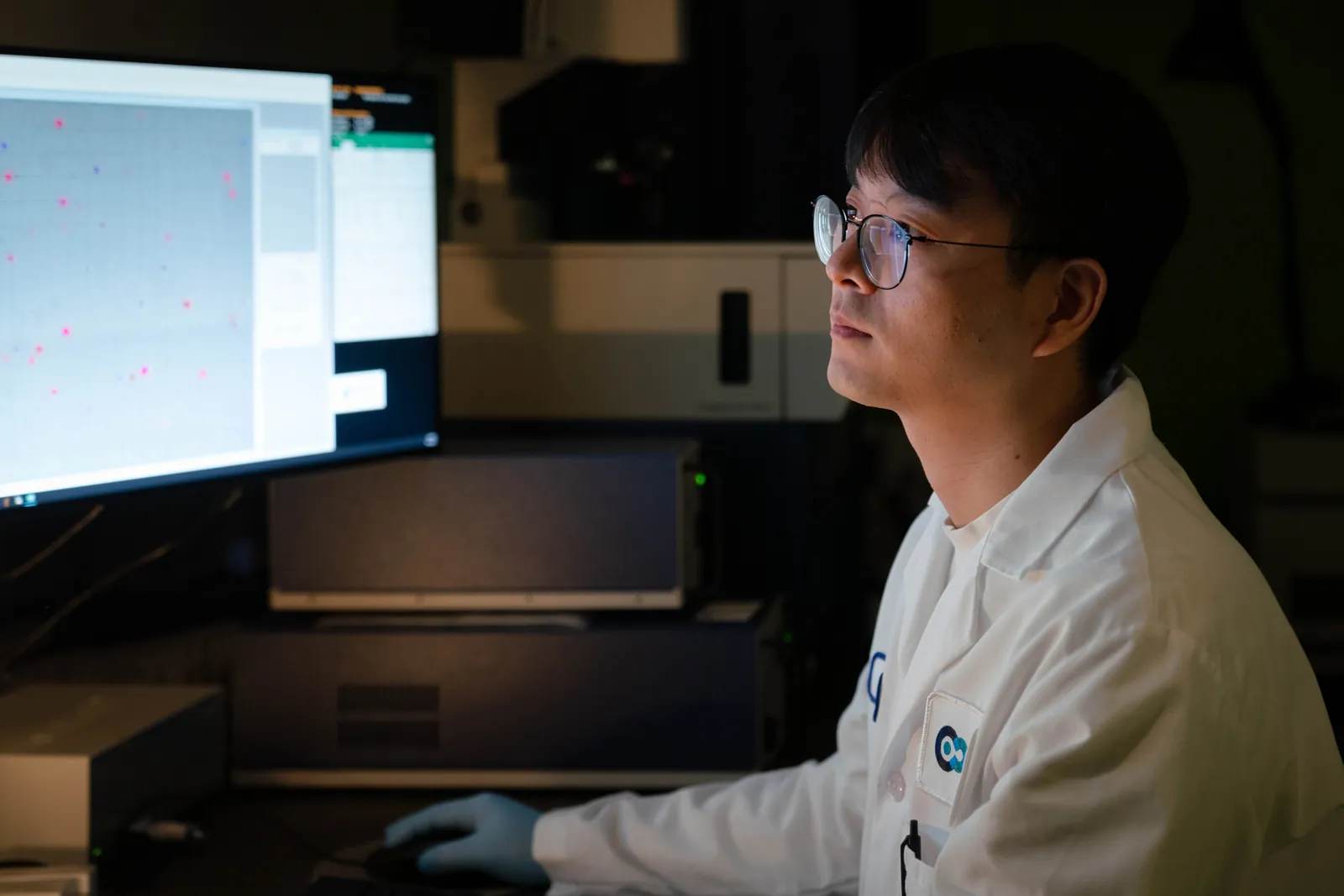 man in a lab coat on a computer