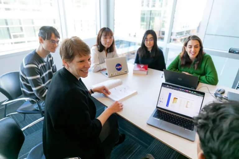 Jennifer Hadlock with lab members in a conference room