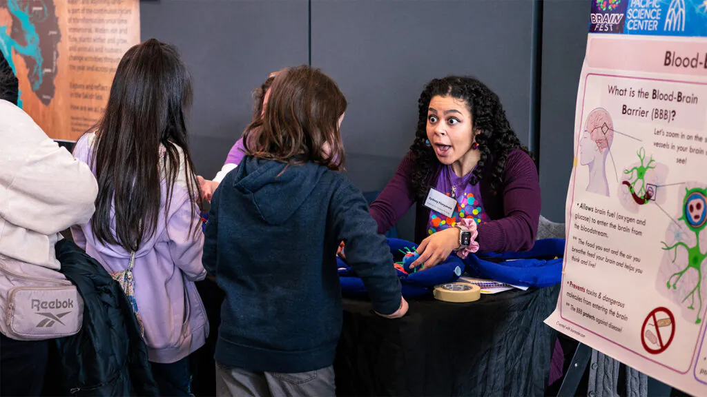 A photo of ISB volunteer Sydney Floryanzia at Pacific Science Center Brainfest.