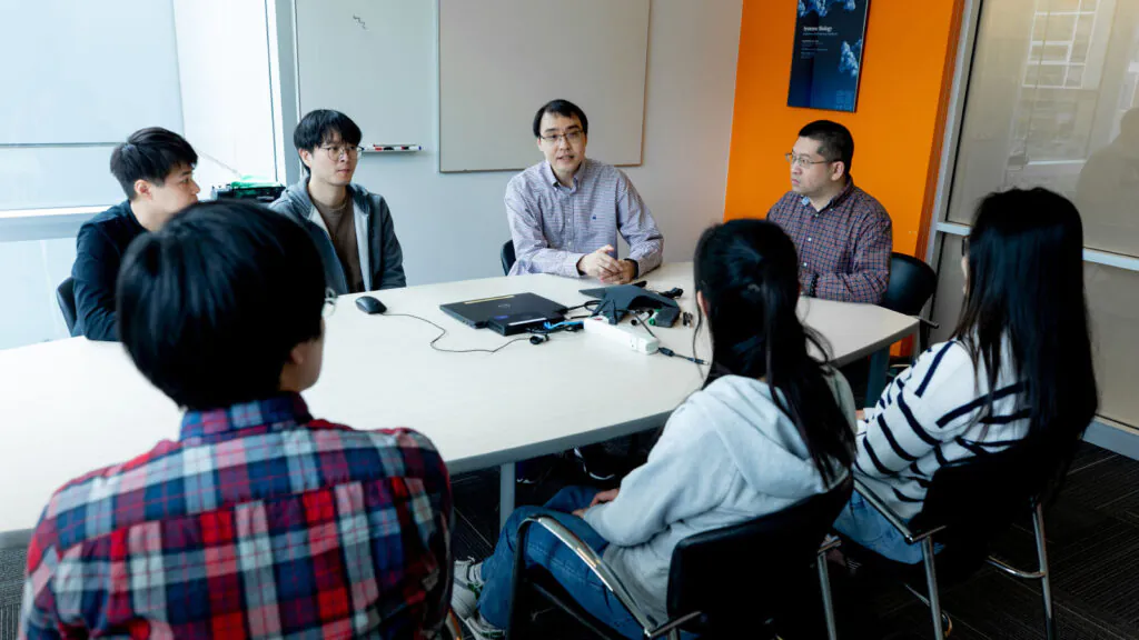 Dr. Wei Wei and members of the Wei Lab in a conference room at ISB in 2024